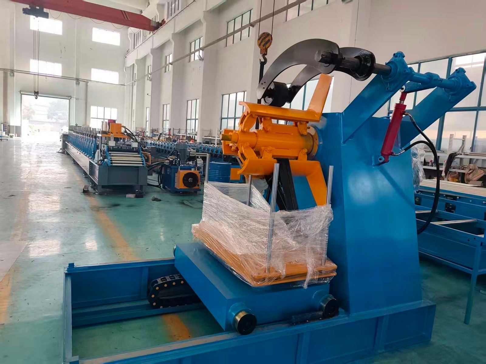 Decoiler and roll forming equipment in the GrandForce workshop